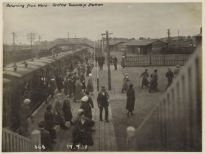 Munition girls going off duty Gretna township station. This photo is from the museum's archive. Some text at the top read "returning form work- Gretna Township station."