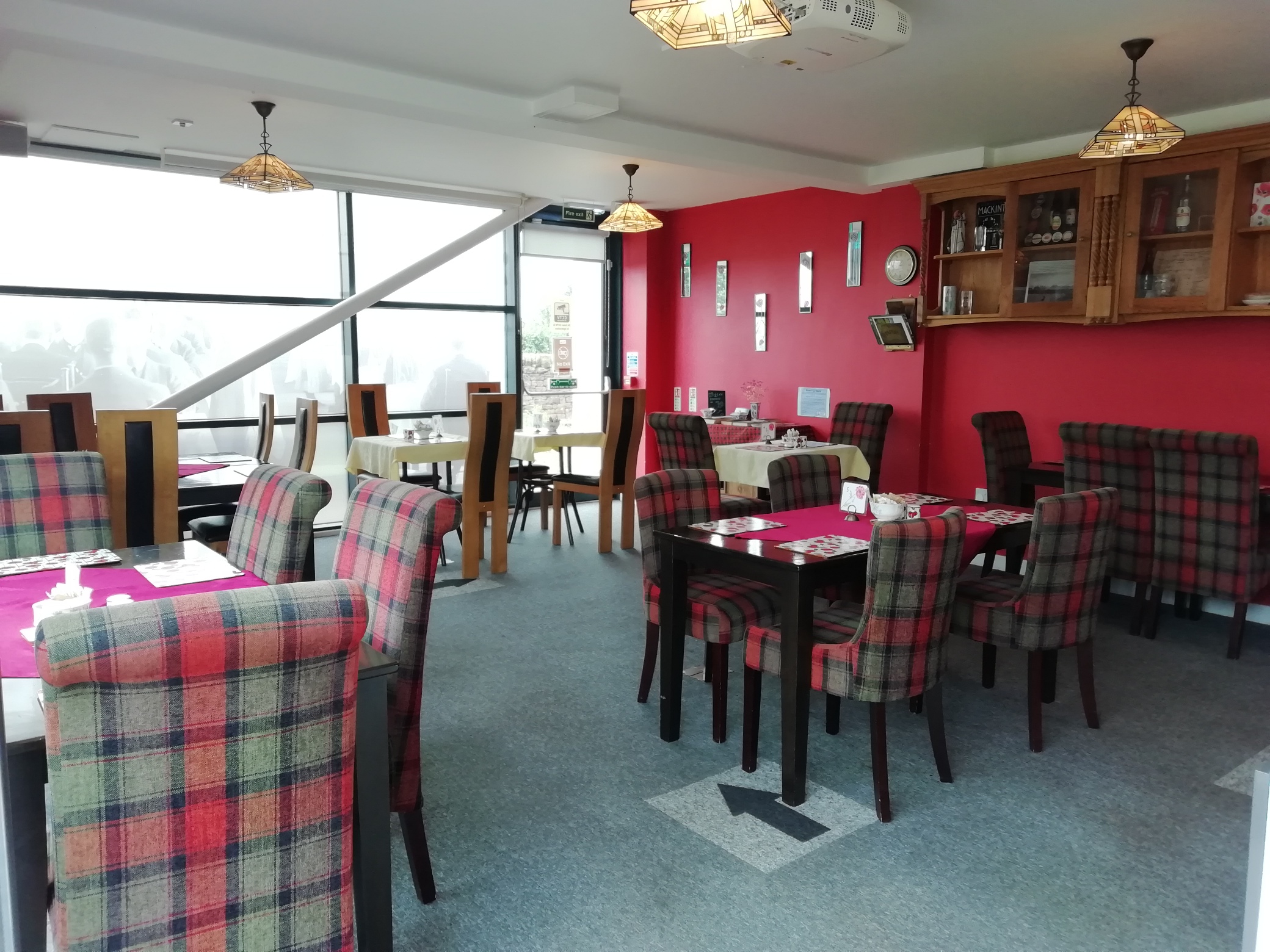 Inside The Devil's Porridge Museum's Café. A selection of chairs and tables are arranged in the room.