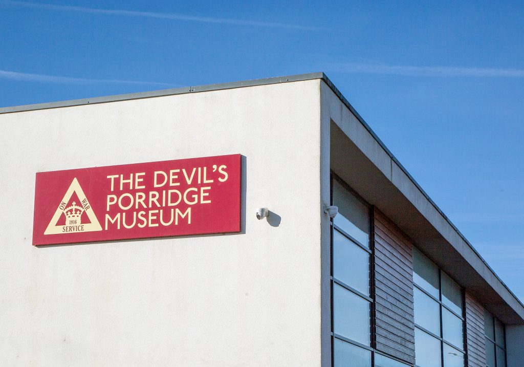 The Devil's Porridge Museum sign on the outside wall of The Devil's Porridge Museum.