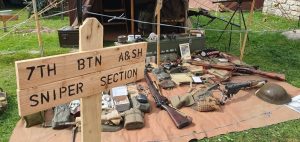 A selection of weaponry and 1940s items on display outside.