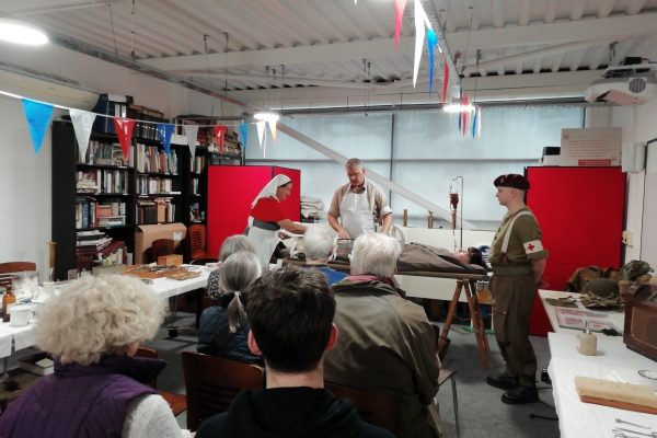 Living History Weekend 2025 15 An audience watching some World War Two living history reenactors demonstrate the application of a splint.