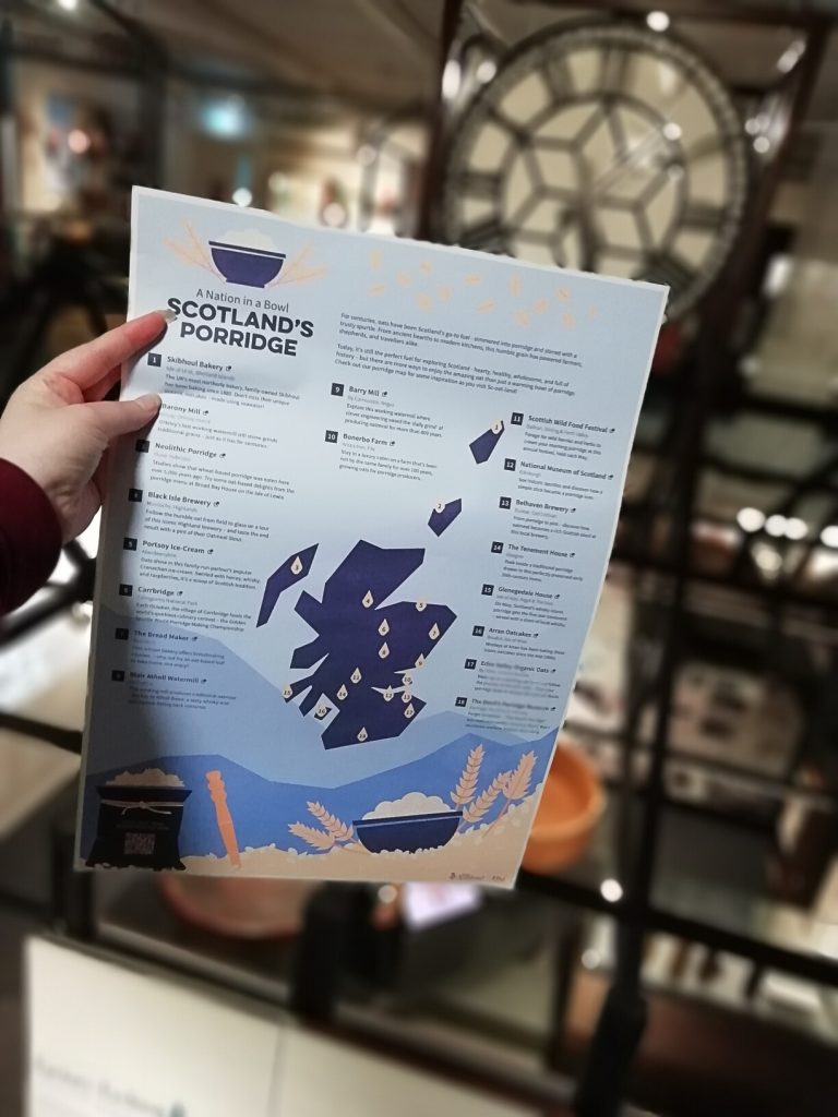 A map for Scotland's Porridge Tour held up inside The Devil's Porridge Museum. A large clock, the Mossband clock can be seen in the background.