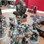 Arrangement of Warhammer miniatures on bases on a table.