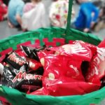 A basket full of sweets with children sat on the floor in the background.