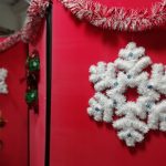 Snowflake decorations and tinsel decorating a display board in The Devil's Porridge Museum's education room.