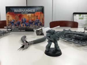 A table with materials and equipment used to make Warhammer miniatures.