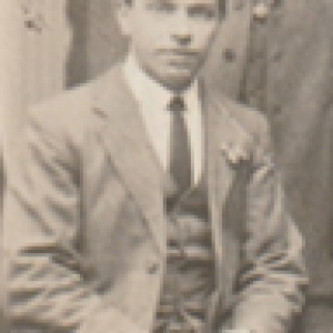 Black and white photo of Wilfred Edmondson sat wearing a suit.