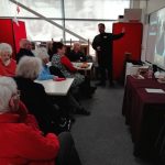 Some retirees sat around three rows of tables with Tom, The Devil's Porridge Museum's Youth and Community Engagement officer stood up talking to them.
