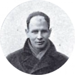 A man with a neutral expression wearing a coat. This is Eric De Clemont in a black and white photo from the past.