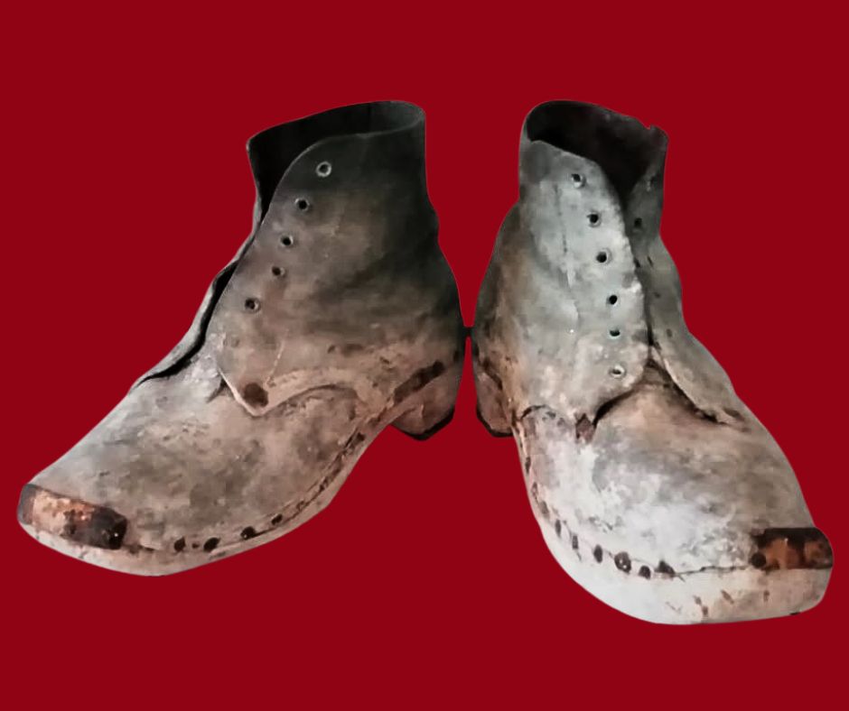 A pair of boots without any shoelaces.